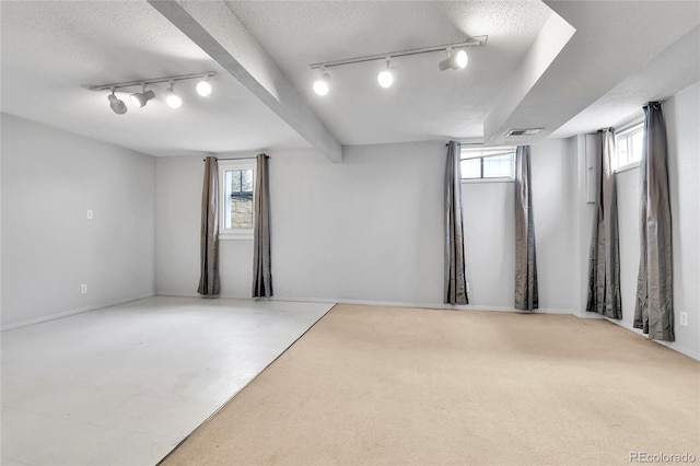 7796 S Marshall Ct, Littleton, CO 80128 - basement featuring rail lighting and a textured ceiling