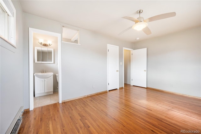 unfurnished bedroom featuring connected bathroom, light hardwood / wood-style flooring, ceiling fan, and sink