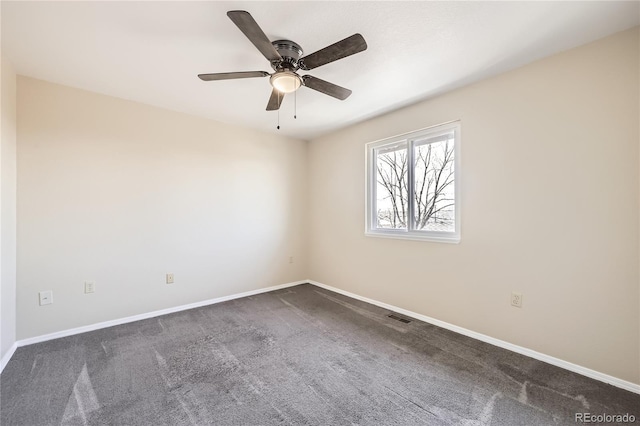 spare room featuring ceiling fan, baseboards, visible vents, and dark carpet