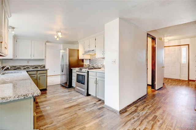 1487 S Zeno Way, Aurora, CO 80017 - kitchen featuring stainless steel appliances, under cabinet range hood, a sink, and light wood-style floors