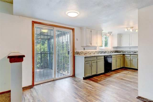 1487 S Zeno Way, Aurora, CO 80017 - kitchen with dishwasher, light wood-style floors, a sink, a textured ceiling, and baseboards