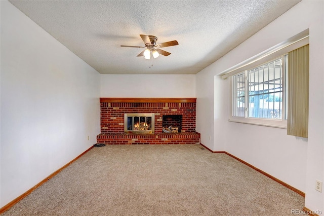 1487 S Zeno Way, Aurora, CO 80017 - unfurnished living room with a ceiling fan, a textured ceiling, carpet flooring, a fireplace, and baseboards