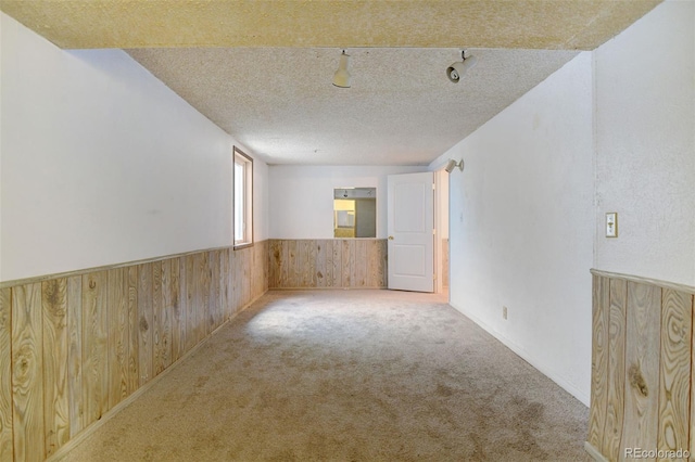 1487 S Zeno Way, Aurora, CO 80017 - carpeted spare room with wood walls, a wainscoted wall, and a textured ceiling