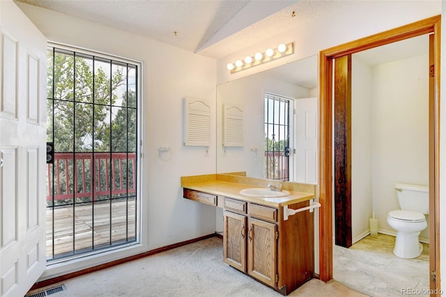 1487 S Zeno Way, Aurora, CO 80017 - bathroom with vaulted ceiling, vanity, toilet, and baseboards