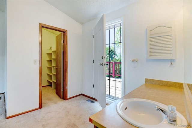 1487 S Zeno Way, Aurora, CO 80017 - bathroom featuring lofted ceiling, baseboards, vanity, and a textured ceiling