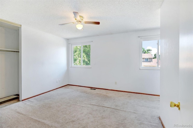 1487 S Zeno Way, Aurora, CO 80017 - unfurnished bedroom with carpet flooring, a textured ceiling, a closet, baseboards, and ceiling fan