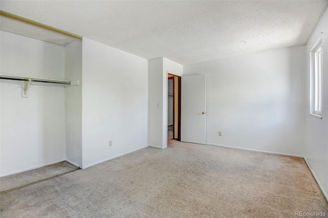 1487 S Zeno Way, Aurora, CO 80017 - unfurnished bedroom featuring carpet flooring, a textured ceiling, and baseboards