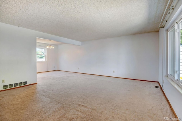 1487 S Zeno Way, Aurora, CO 80017 - carpeted spare room with a chandelier, a textured ceiling, and baseboards