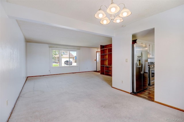 1487 S Zeno Way, Aurora, CO 80017 - unfurnished room featuring carpet floors, baseboards, and a chandelier