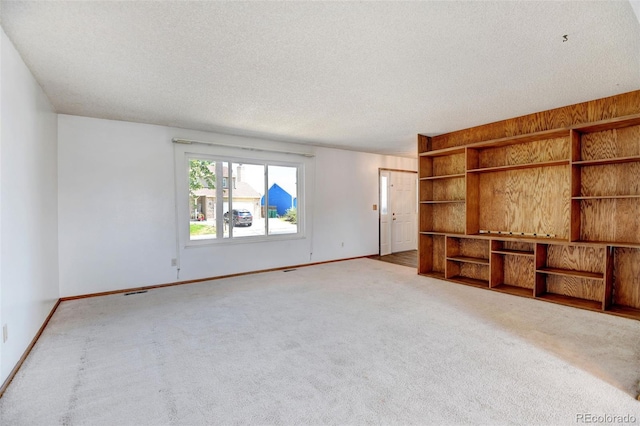1487 S Zeno Way, Aurora, CO 80017 - unfurnished living room featuring carpet floors, a textured ceiling, and baseboards