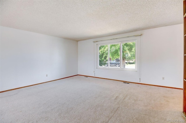 1487 S Zeno Way, Aurora, CO 80017 - carpeted empty room featuring a textured ceiling and baseboards