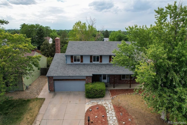 1487 S Zeno Way, Aurora, CO 80017 - traditional-style house featuring concrete driveway, roof with shingles, a garage, and brick siding