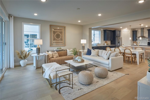 4145 N Duquesne Ct, Aurora, CO 80019 - living area featuring recessed lighting, light wood-type flooring, and baseboards