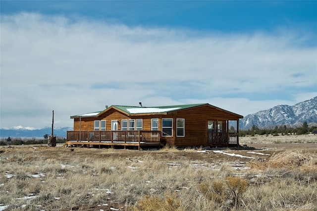 back of house with a deck with mountain view