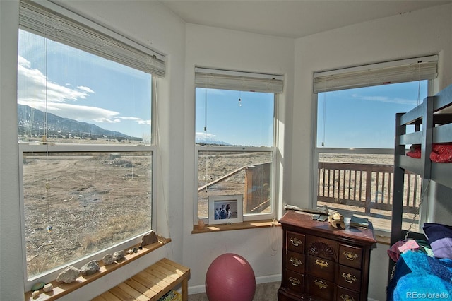 sunroom / solarium with a mountain view and a healthy amount of sunlight