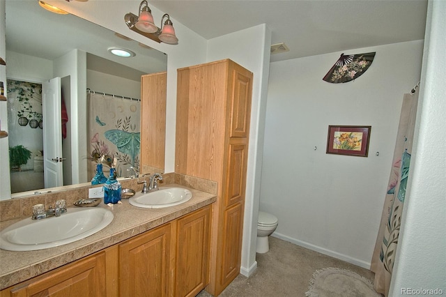 bathroom featuring vanity and toilet