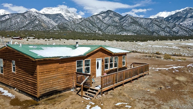 exterior space featuring a deck with mountain view