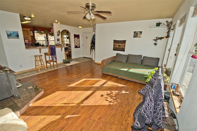 living room with hardwood / wood-style flooring and ceiling fan