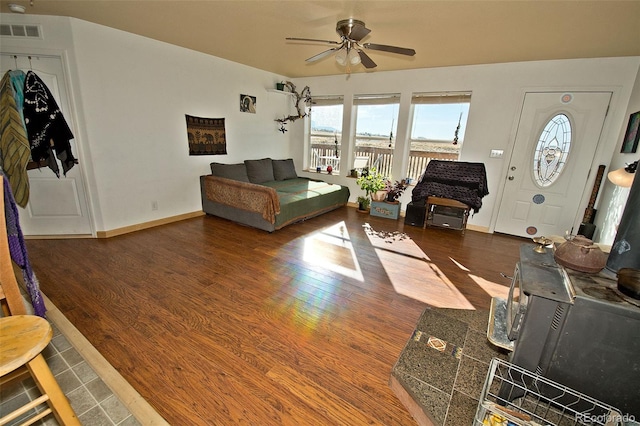 living room with ceiling fan and dark hardwood / wood-style flooring