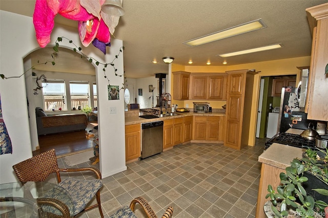 kitchen featuring sink, a textured ceiling, and dishwasher