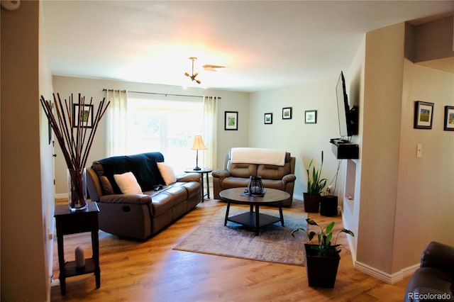 3825 S Monaco Pkwy Unit 111, Denver, CO 80237 - living room with light wood-style floors, a chandelier, and baseboards