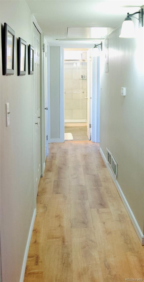 3825 S Monaco Pkwy Unit 111, Denver, CO 80237 - hallway featuring baseboards, attic access, and light wood-style flooring