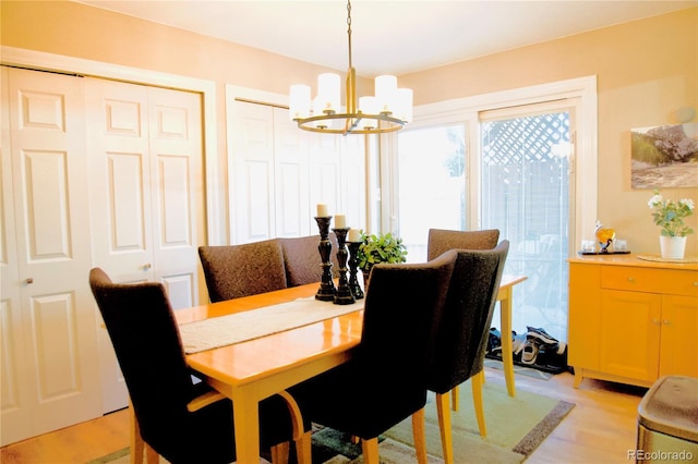 3825 S Monaco Pkwy Unit 111, Denver, CO 80237 - dining space with a chandelier and light wood-style flooring