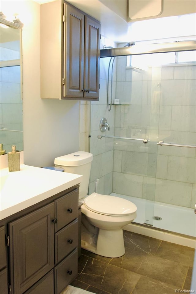 3825 S Monaco Pkwy Unit 111, Denver, CO 80237 - full bath with vanity, a shower stall, and toilet