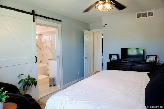 3825 S Monaco Pkwy Unit 111, Denver, CO 80237 - bedroom featuring a barn door, carpet flooring, ceiling fan, connected bathroom, and baseboards