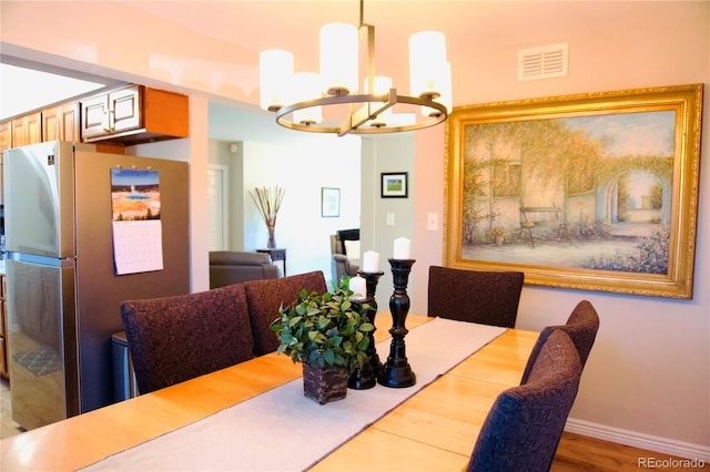 3825 S Monaco Pkwy Unit 111, Denver, CO 80237 - dining room with a chandelier and baseboards