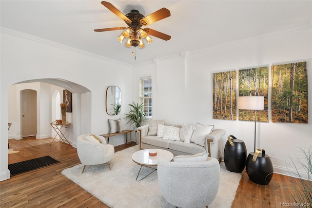 living room featuring ornamental molding, hardwood / wood-style flooring, and ceiling fan