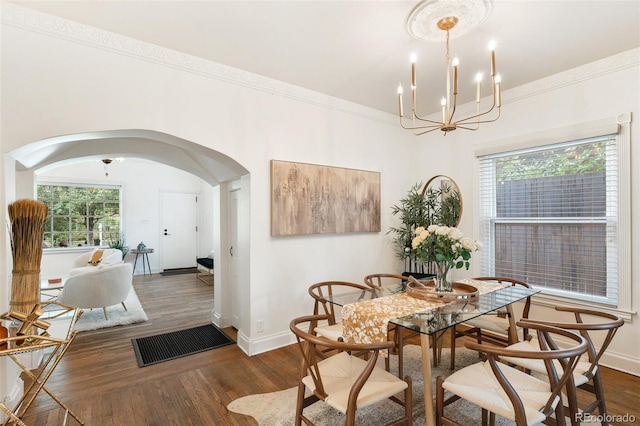 dining room with a notable chandelier, dark hardwood / wood-style floors, and ornamental molding