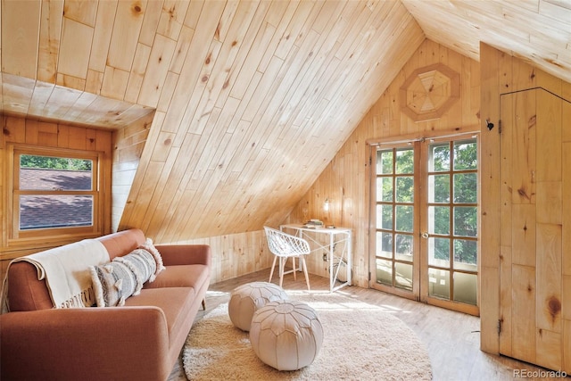 additional living space featuring wooden ceiling, vaulted ceiling, wooden walls, and light hardwood / wood-style floors