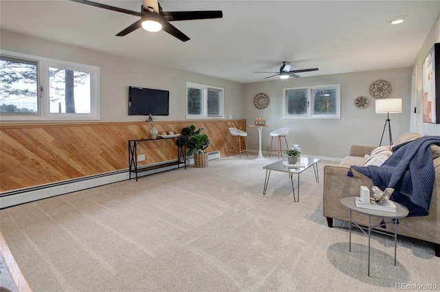 14650 Tejon St, Broomfield, CO 80023 - living room featuring a ceiling fan, carpet floors, wooden walls, a baseboard heating unit, and a wainscoted wall