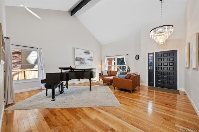 foyer featuring beam ceiling, wood-type flooring, high vaulted ceiling, and a chandelier