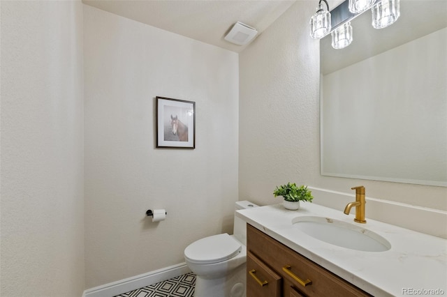 bathroom featuring tile patterned flooring, vanity, and toilet