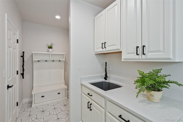 washroom with light tile patterned floors and sink