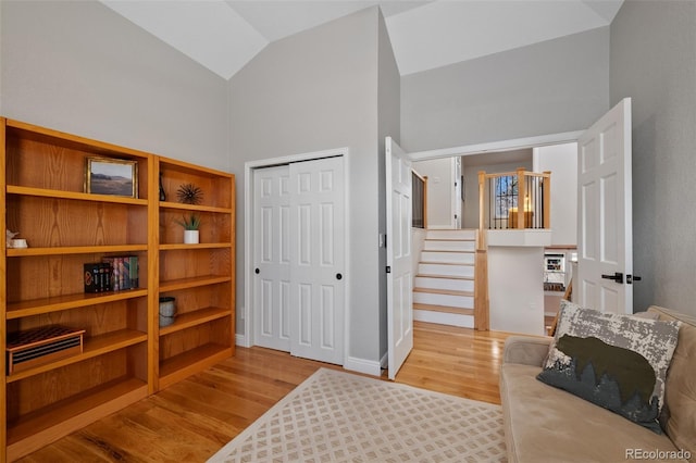 interior space with high vaulted ceiling and light wood-type flooring