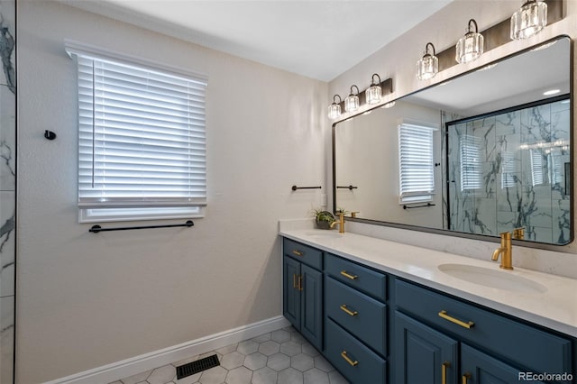 bathroom with tile patterned floors, vanity, and an enclosed shower