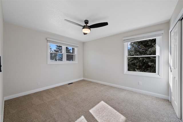 unfurnished room featuring carpet and ceiling fan