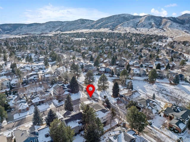 snowy aerial view featuring a mountain view