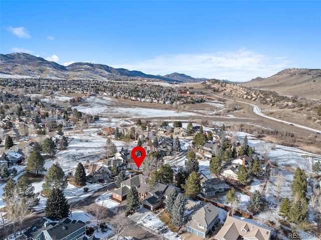 snowy aerial view featuring a mountain view