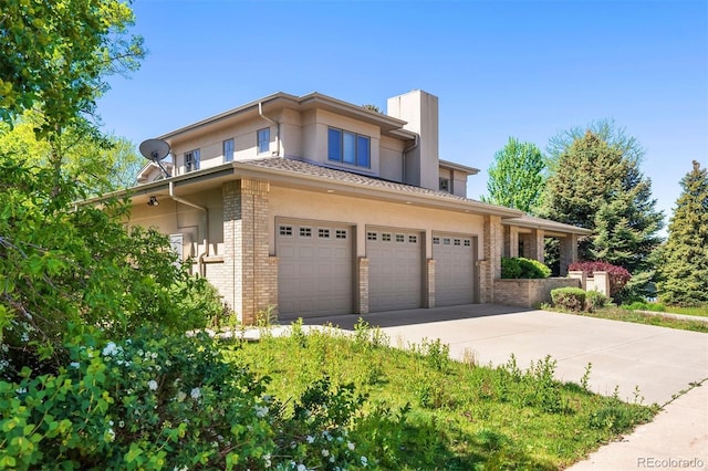 4800 E Cedar Ave, Denver, CO 80246 - prairie-style house with a chimney, brick siding, concrete driveway, and stucco siding