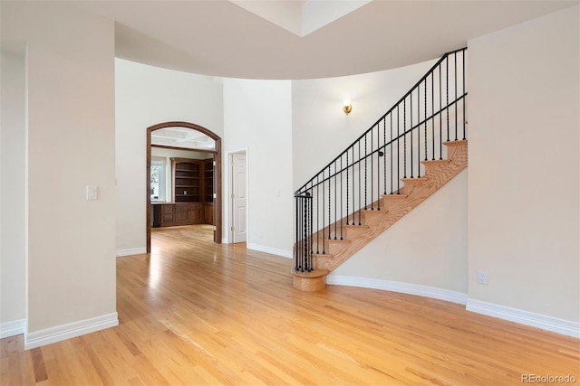 4800 E Cedar Ave, Denver, CO 80246 - foyer entrance with wood finished floors, baseboards, stairs, and arched walkways