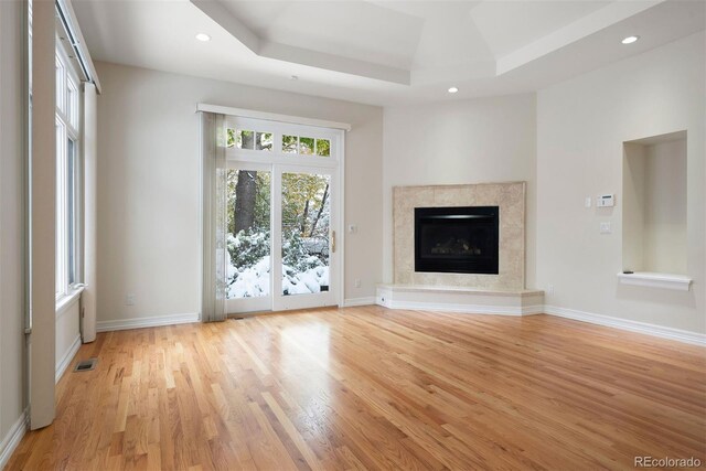4800 E Cedar Ave, Denver, CO 80246 - unfurnished living room with light wood-type flooring, a raised ceiling, recessed lighting, and baseboards