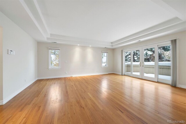 4800 E Cedar Ave, Denver, CO 80246 - unfurnished room featuring a raised ceiling, healthy amount of natural light, light wood finished floors, baseboards, and recessed lighting