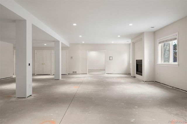 4800 E Cedar Ave, Denver, CO 80246 - unfurnished living room with recessed lighting, unfinished concrete floors, and a glass covered fireplace