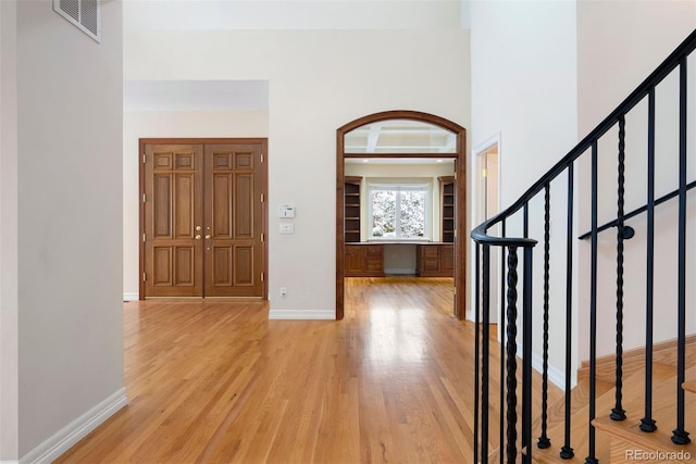 4800 E Cedar Ave, Denver, CO 80246 - foyer featuring light wood finished floors, stairs, and baseboards