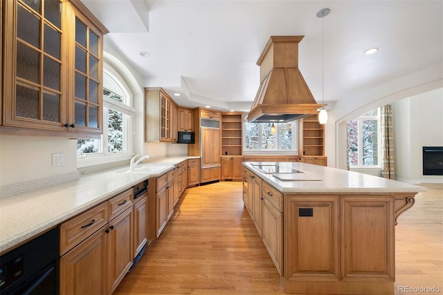 4800 E Cedar Ave, Denver, CO 80246 - kitchen with a sink, black appliances, light wood finished floors, a kitchen island, and recessed lighting
