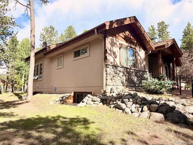 185 Wildrose Ct, Woodland Park, CO 80863 - view of side of property featuring stone siding and stucco siding